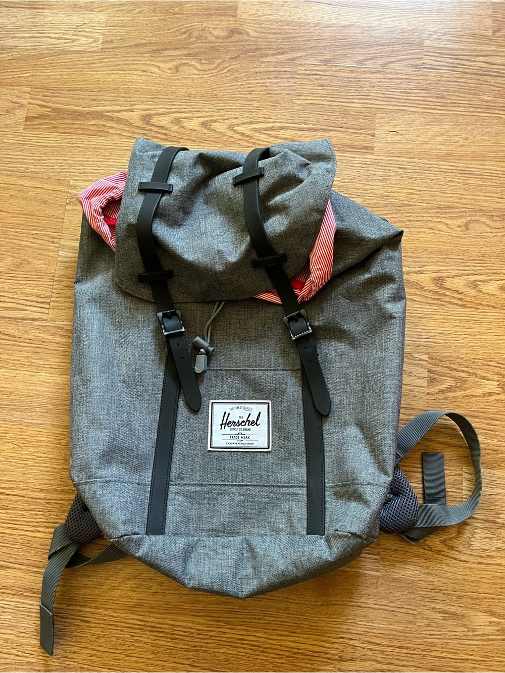 a Herschel Retreat Backpack in gray crosshatch with black straps